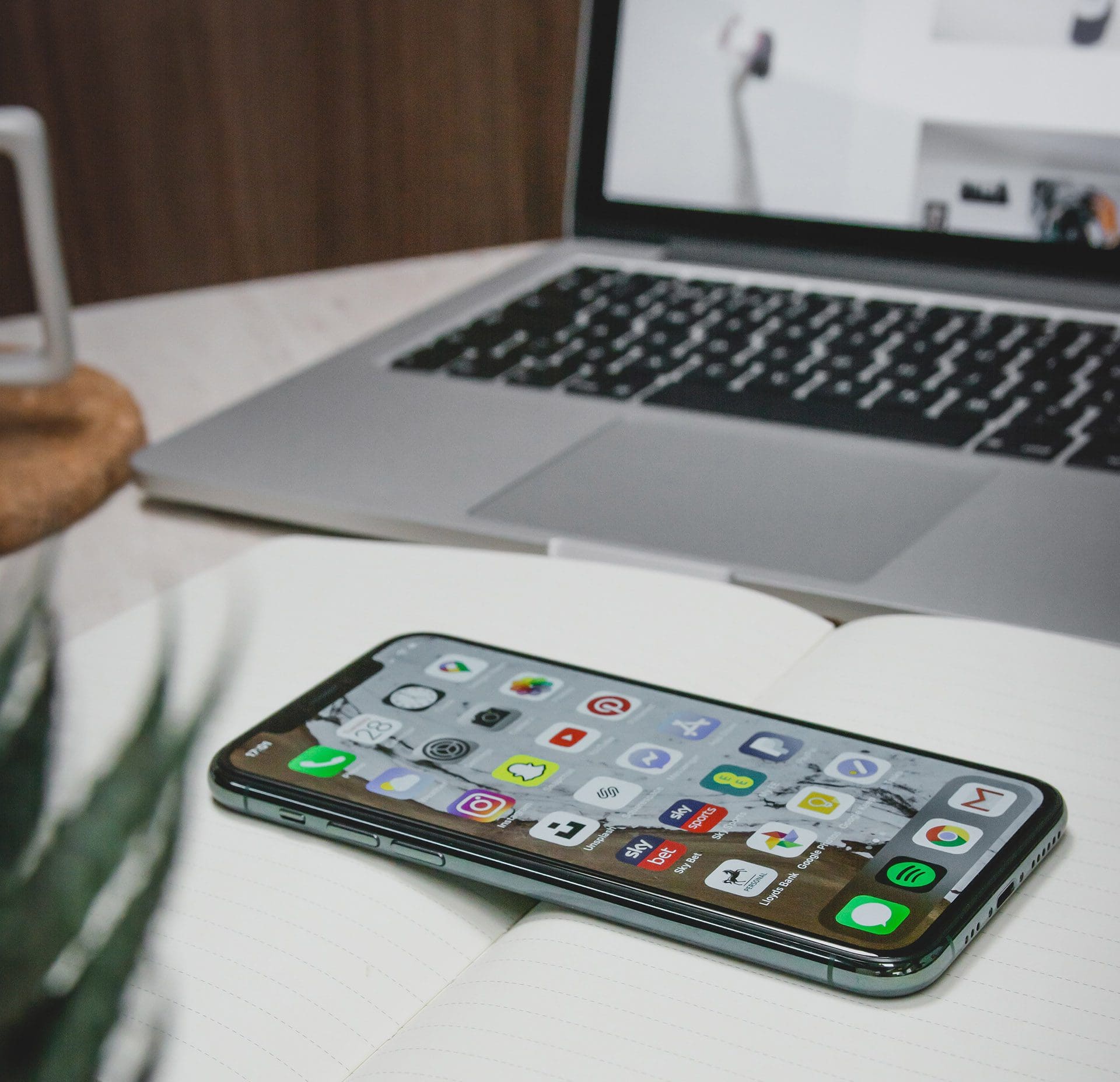 Open laptop and iPhone on a notebook, captured by Nice Branding, a leading Nashville digital marketing agency.
